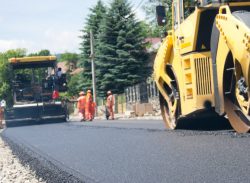 Construction workers paving a road