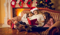 Family reading Christmas stories by the fire