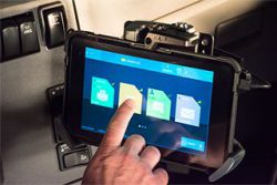 Journey 8 electronic logging tablet in use by a driver in a truck cab, by iGlobal, LLC